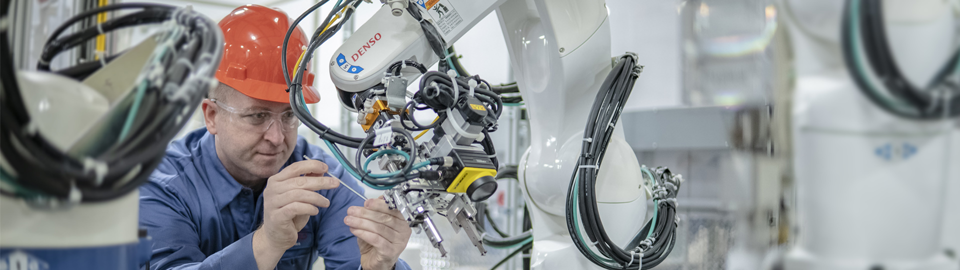 Skilled Trades Man Working on Robot