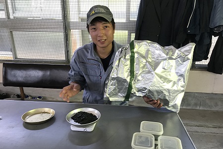 Student mixing Coccomyxa KJ into feed
