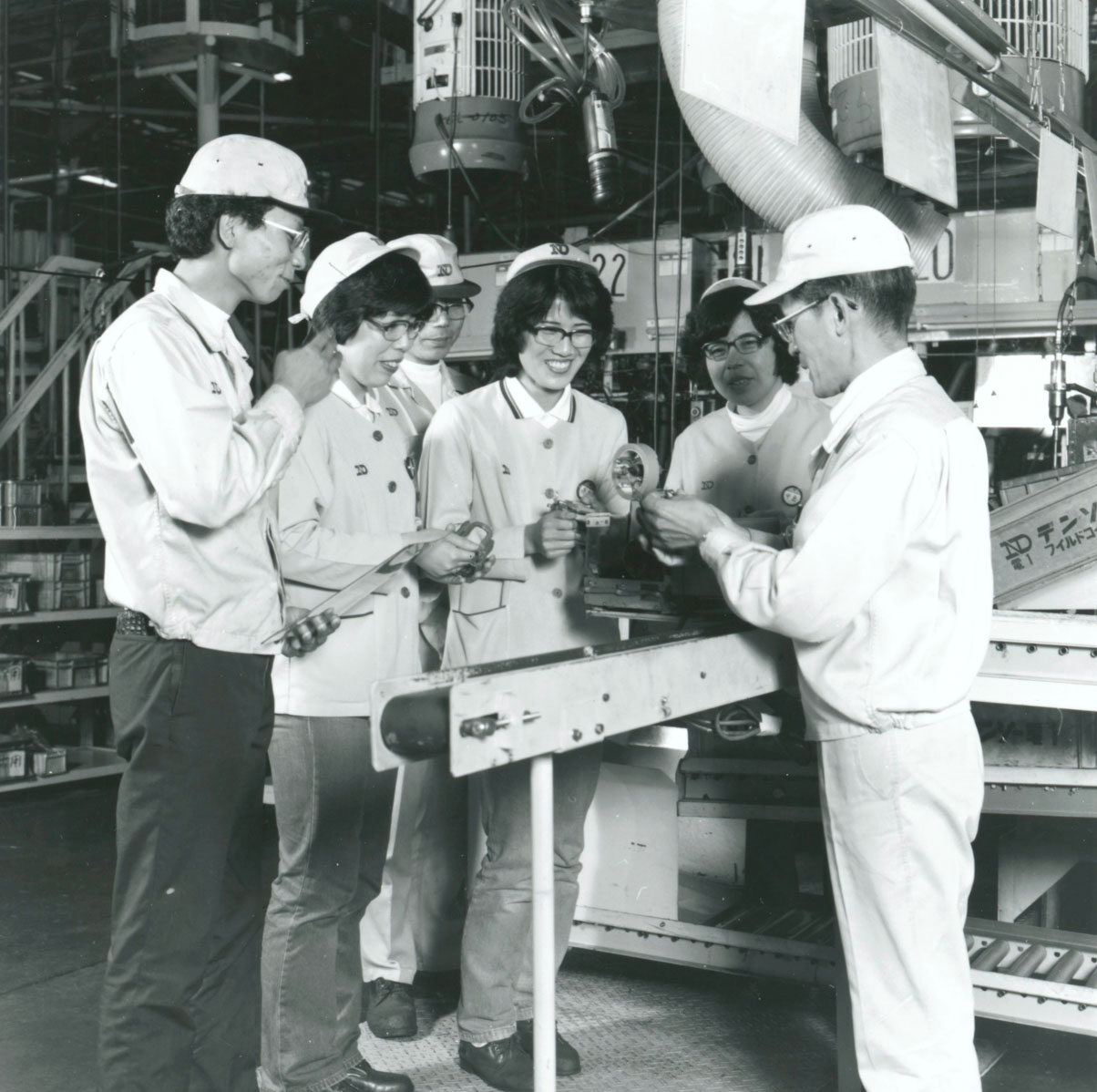 DENSO’s first company Quality Circle (QC) competition was held November 1971 in Japan. The first gold prize was awarded to the Yokonirami Circle team (pictured) of the starter production line.