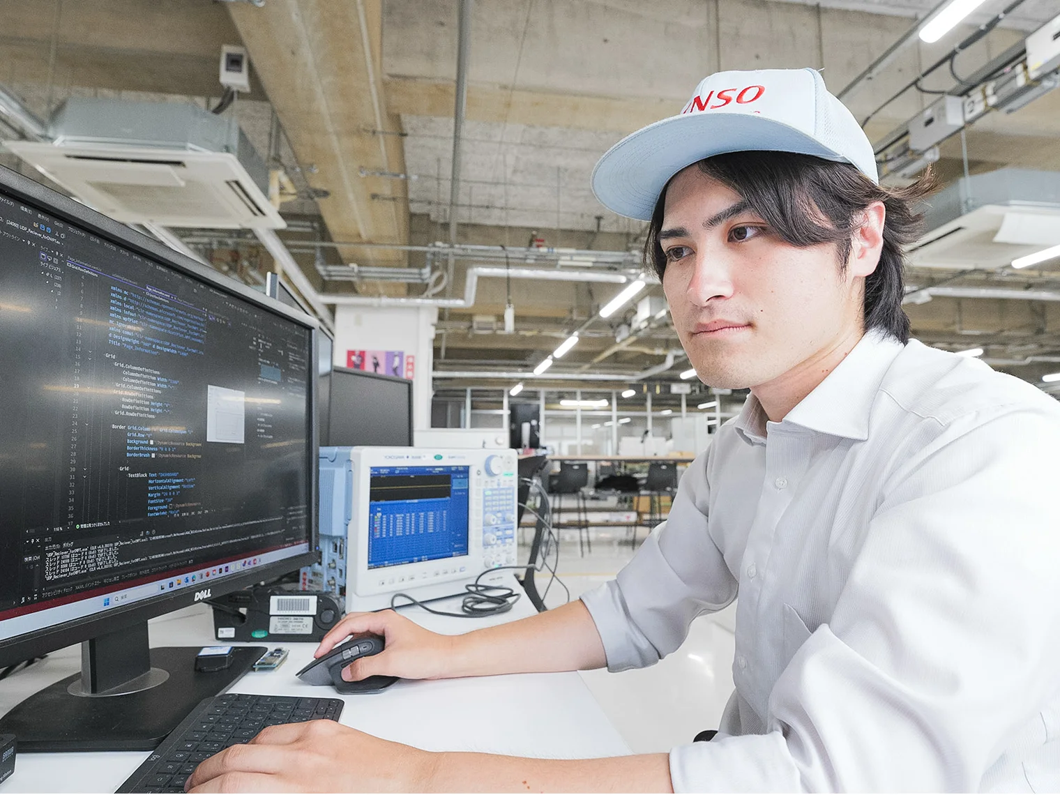 Tetsushi Matsushima developing a system at a desk.