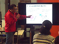 写真は、まず最初に全体の流れと作り方を参加者に説明している様子。この日は親子参加企画です。