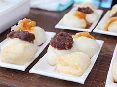 写真は、長方形の発泡食品トレイ皿に、きなこ・あんこ・だいこんおろしの乗った餅が並べられている様子