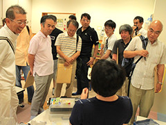 写真は、修理道具や修理方法について熱心に聞く参加者の様子