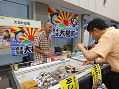 写真は、東日本の名産品を購入する来場者の様子
