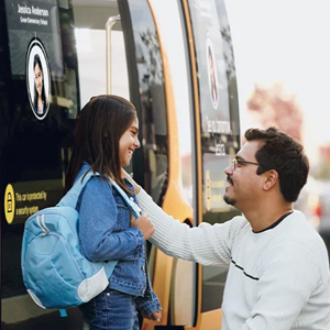 Man Greeting Girl in Front of Software Car