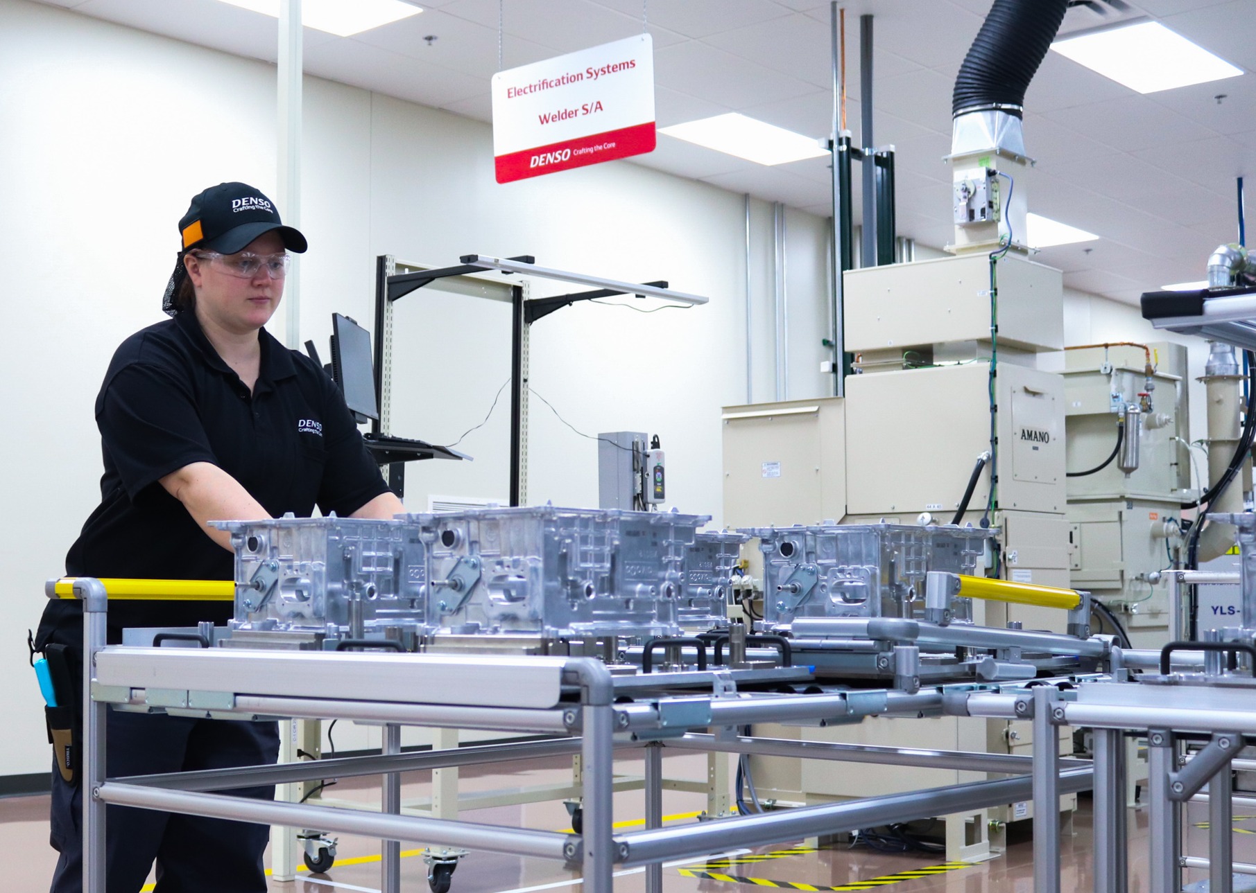 Woman assembles electric automotive components