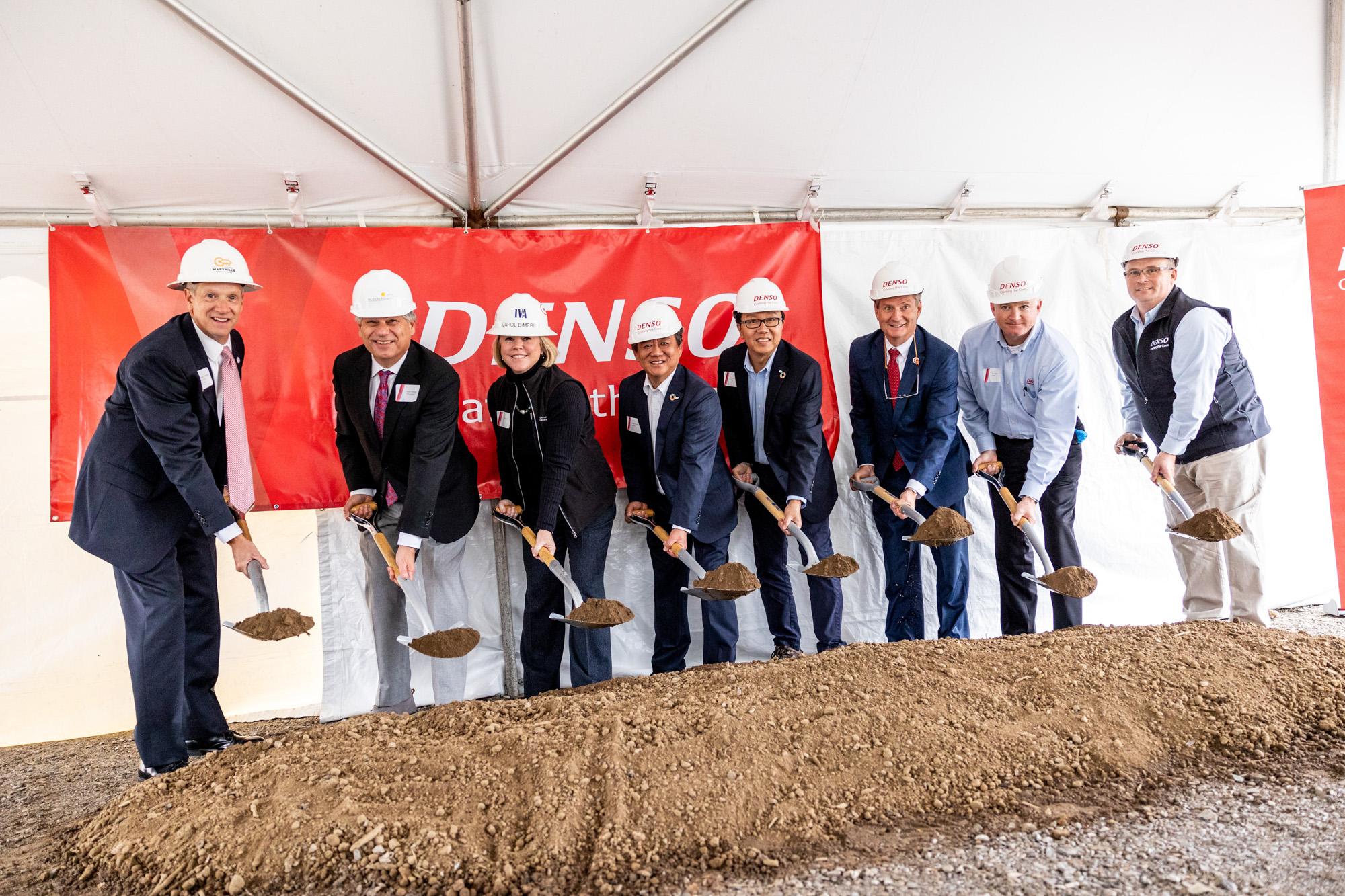 People with shovels breaking ground