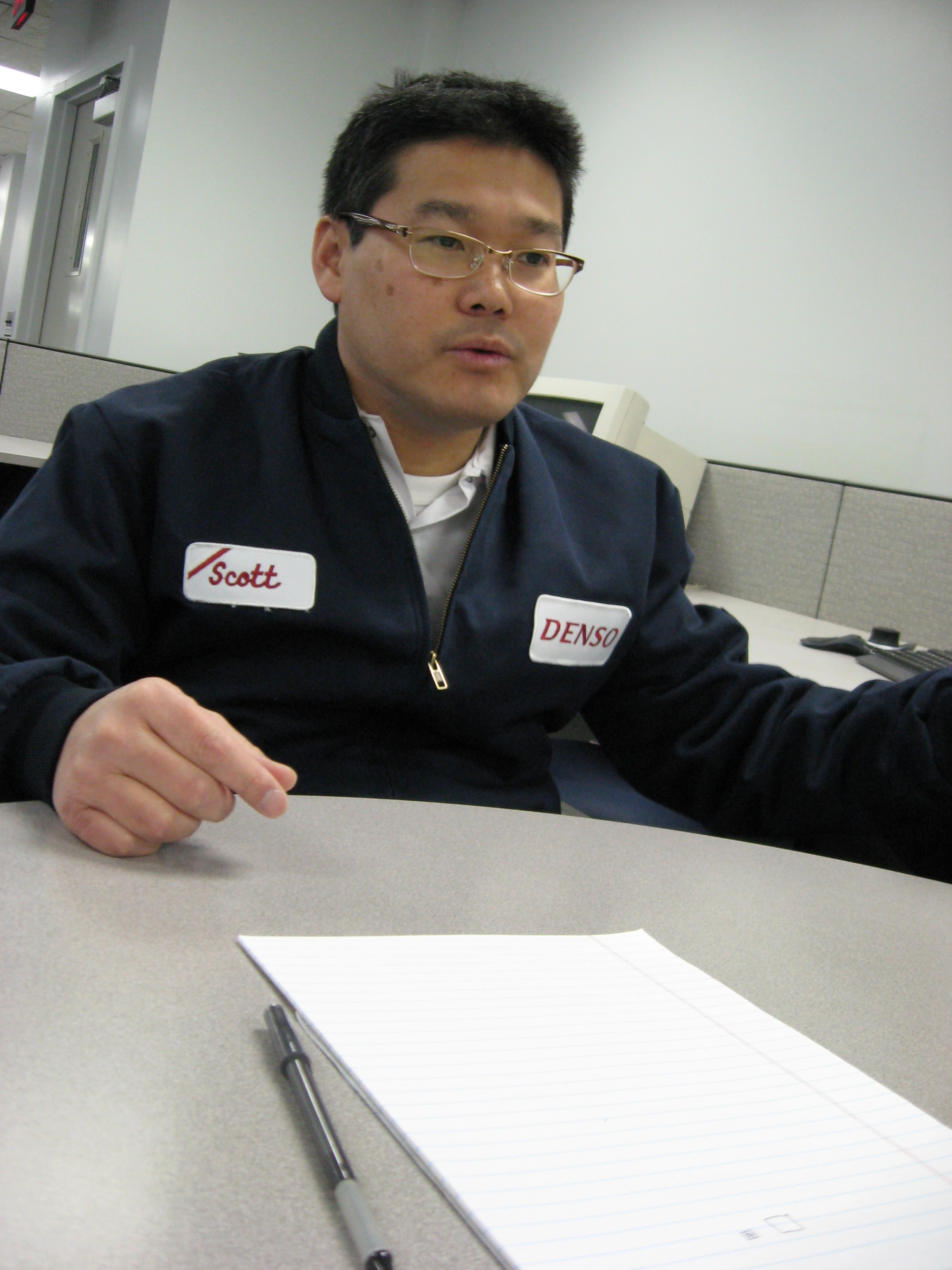 Scott Sits in a chair speaking