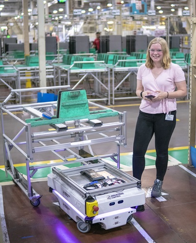 Coop Stands near an Automated Vehicle