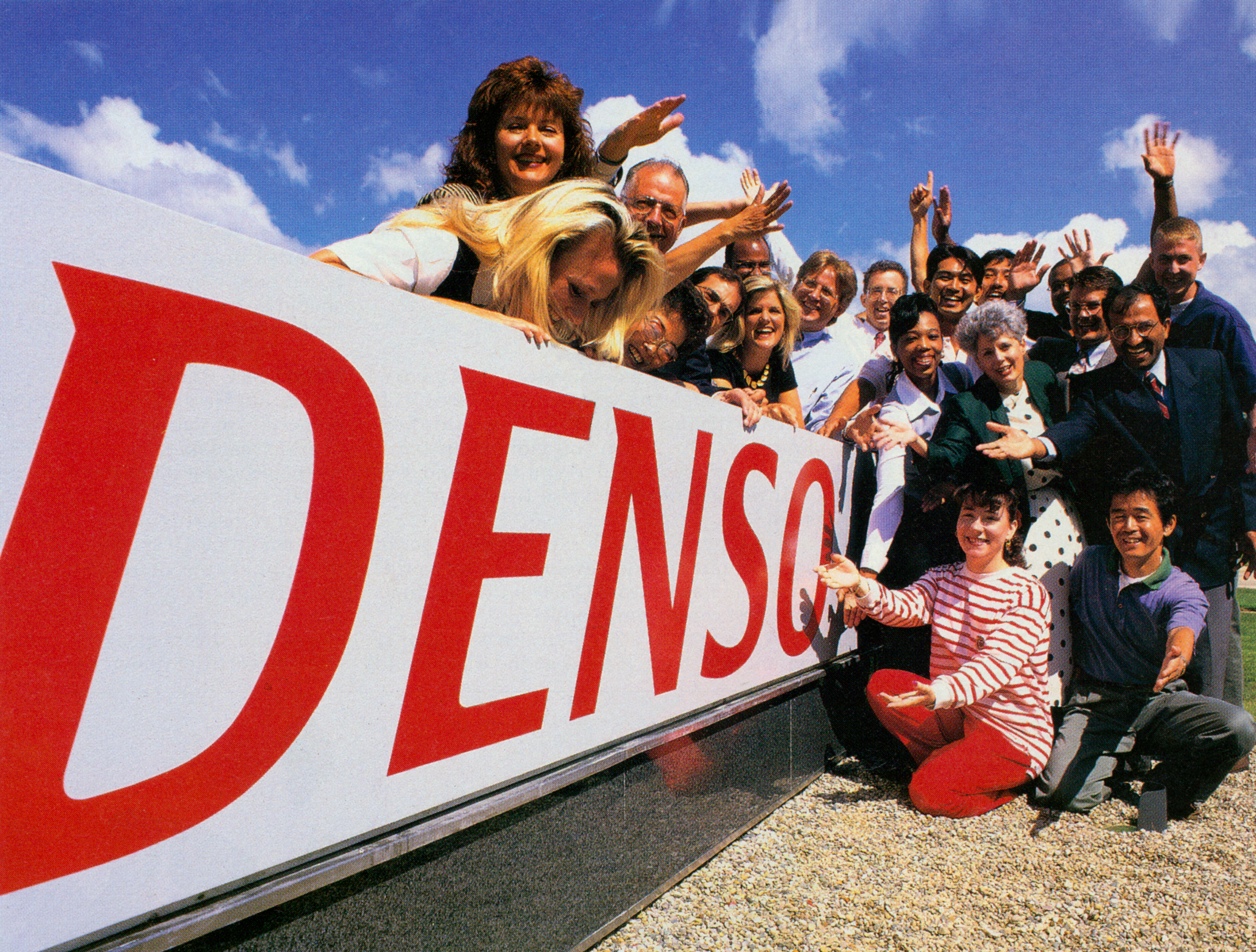 People celebrating around new logo