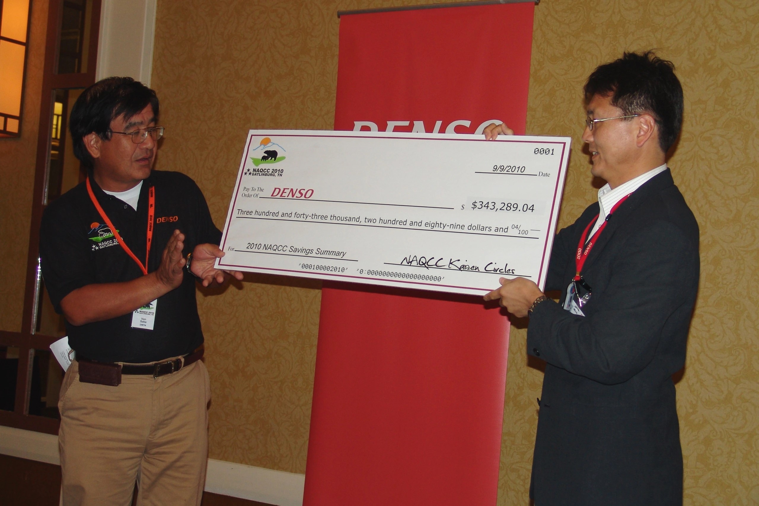 DENSO Team Members with Large Check