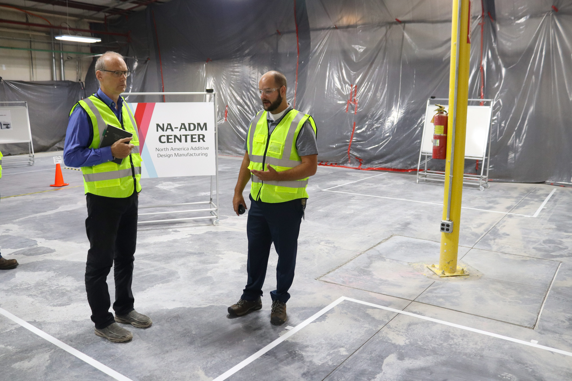 DENSO Team Members stand in future location of ADM