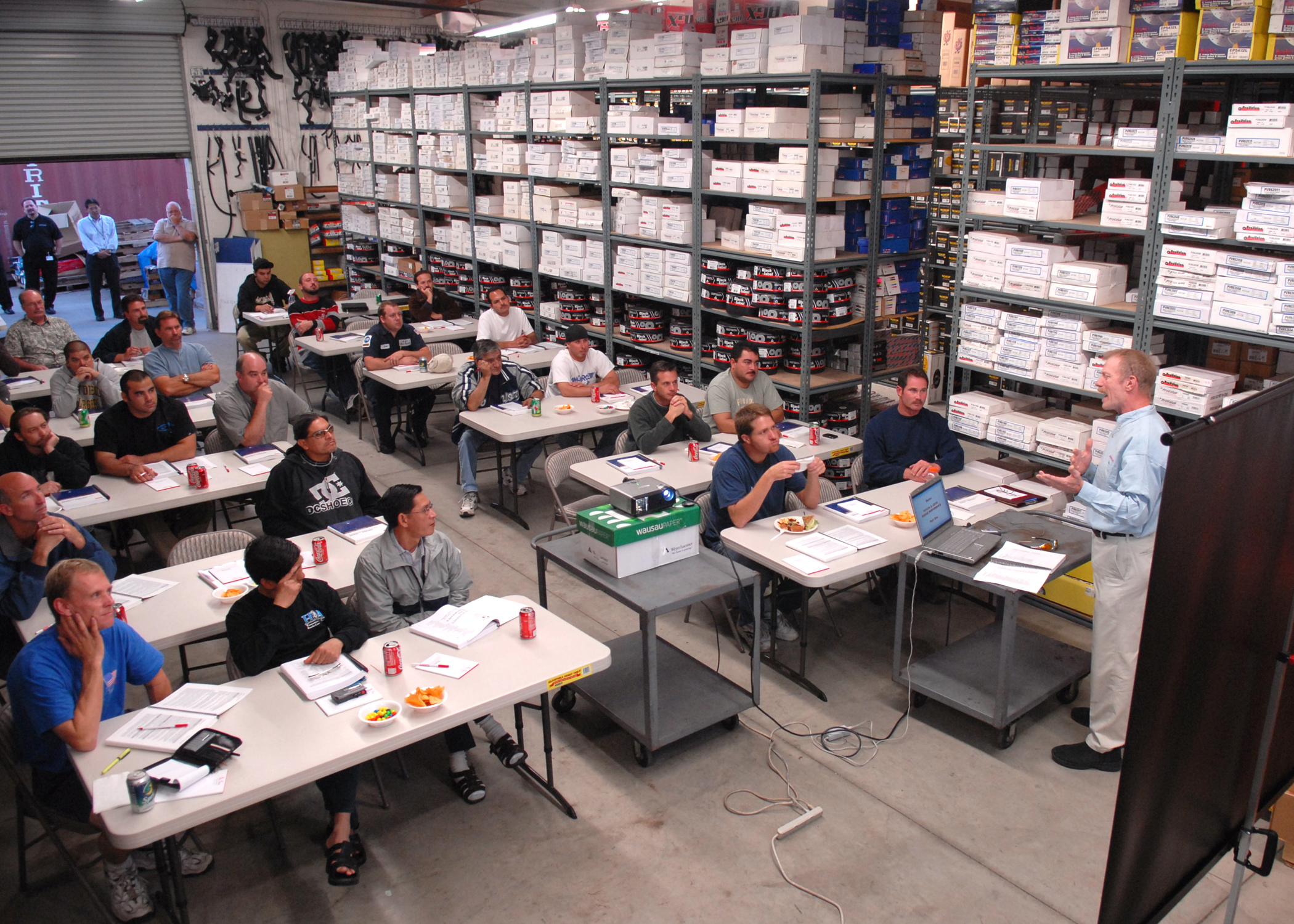 People in a warehouse in a meeting