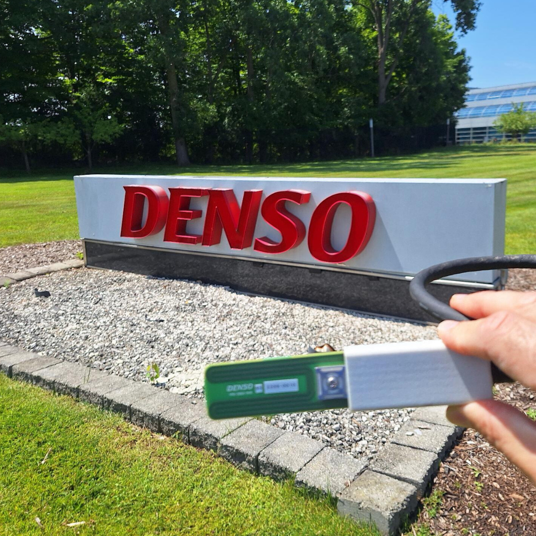 DENSO's Irrigation Sensor in front of DENSO Sign